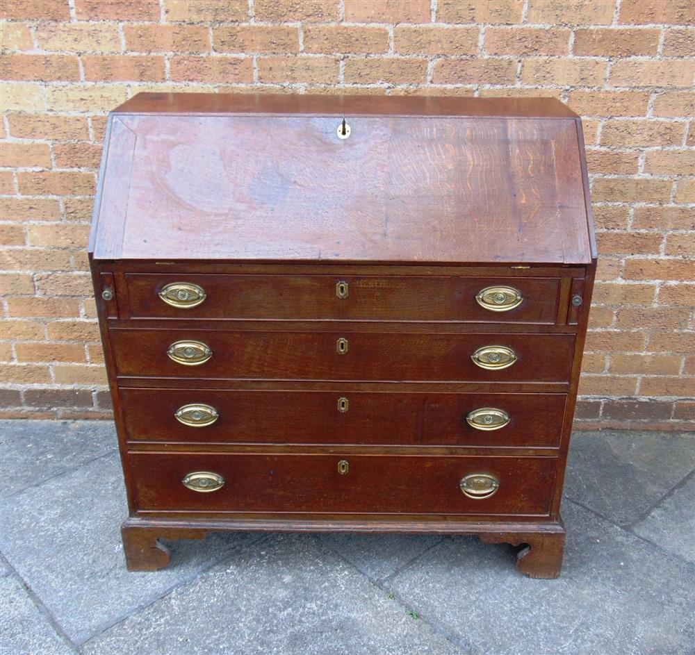 A GEORGE III OAK BUREAU  with fitted interior over four long drawers on bracket feet, 102cm wide - Image 2 of 4