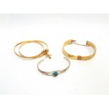 A PAIR OF BANGLES stamped 720, Persian, joined by a baton with a sphere and plane charm attached,