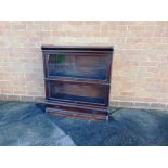 A GLOBE WERNICKE TYPE OAK SECTIONAL BOOKCASE  of two glazed sections, the base fitted with drawer,