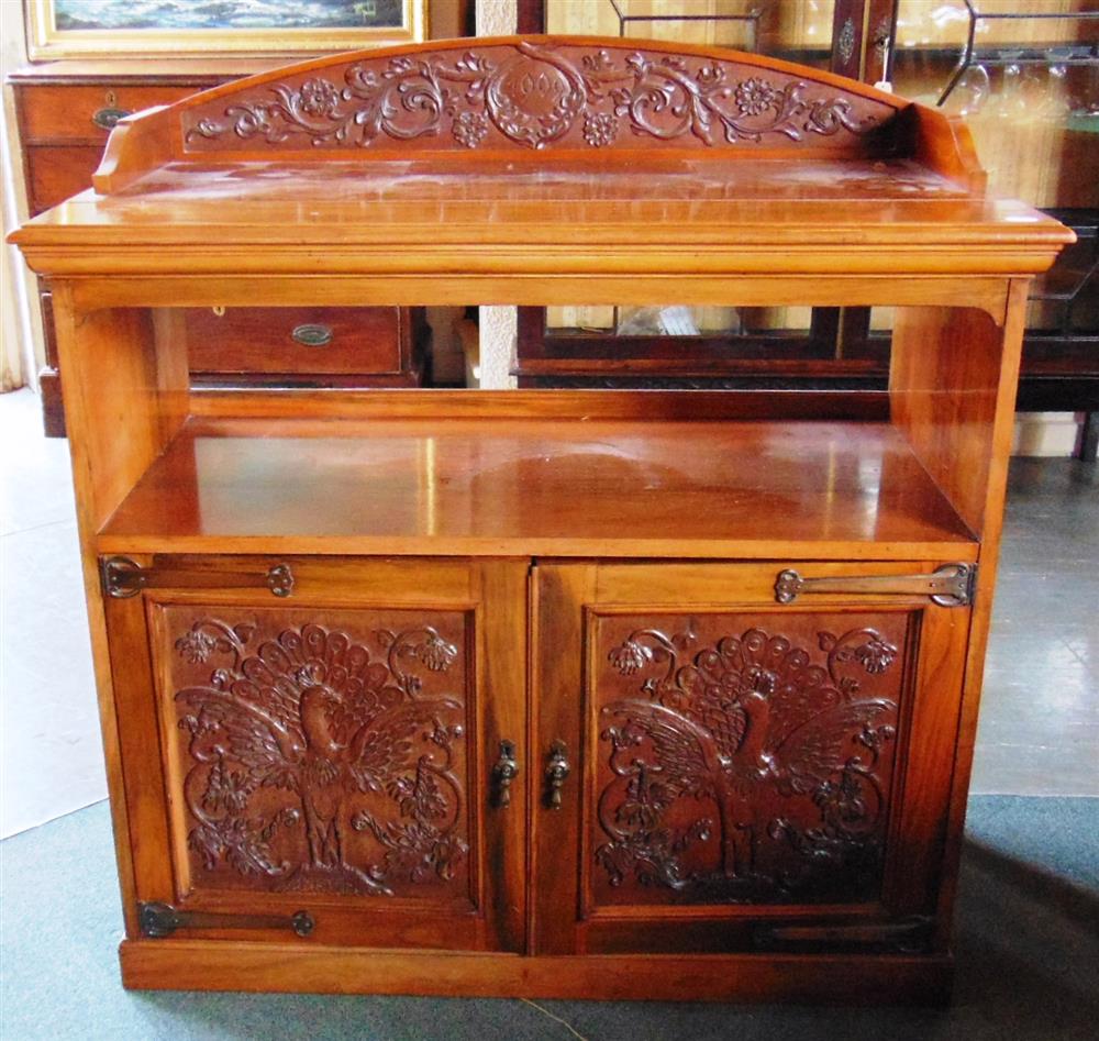 AN EDWARDIAN CARVED WALNUT BUFFET,  the doors carved with peacocks and with strap hinges in the Arts