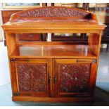 AN EDWARDIAN CARVED WALNUT BUFFET,  the doors carved with peacocks and with strap hinges in the Arts