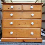 A STRIPPED PINE CHEST OF TWO SHORT AND THREE LONG DRAWERS, with ceramic handles, on plinth base,