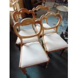 A SET OF FOUR VICTORIAN WALNUT BALLOON BACK DINING CHAIRS, on turned front supports