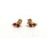 A PAIR OF RUBY AND DIAMOND EARRINGS each set with two pendeloque cut rubies with four diamonds