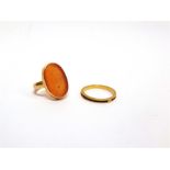 A PERSIAN CORNELIAN SEAL RING the oval panel inscribed with script; with another ring; 6.3g gross