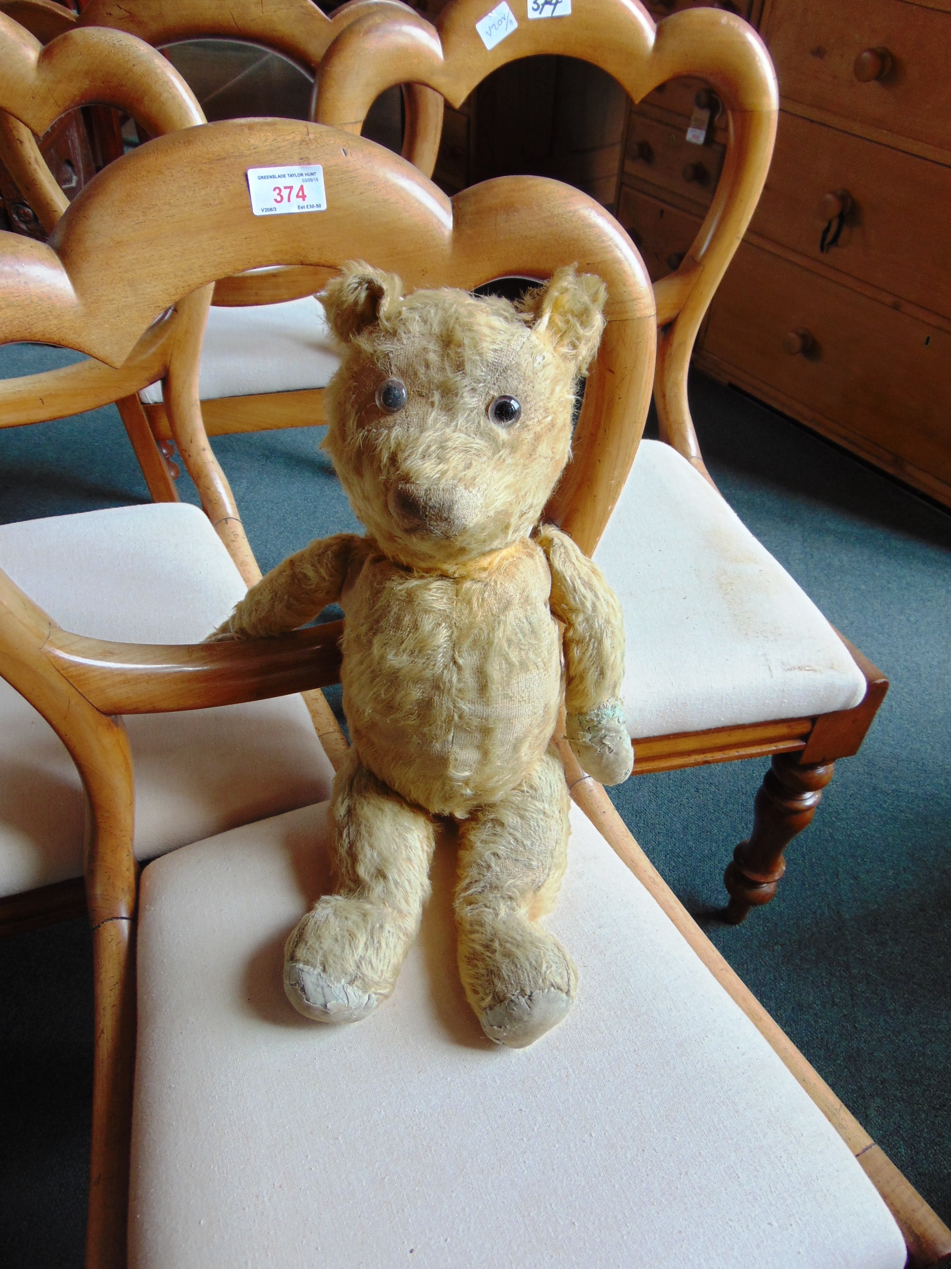 AN ENGLISH GOLD MOHAIR TEDDY BEAR mid 20th century, with clear glass eyes and a brown vertically