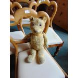 AN ENGLISH GOLD MOHAIR TEDDY BEAR mid 20th century, with clear glass eyes and a brown vertically