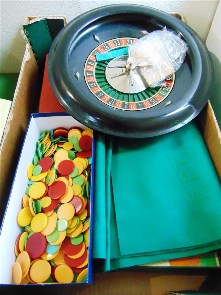 A ROULETTE WHEEL with associated cloth and counters; together with a Totopoly game.