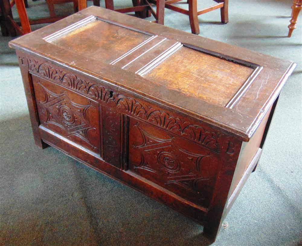 A SMALL OAK COFFER OF PANELLED CONSTRUCTION  with carved decoration, 91cm wide 48cm deep 52cm high