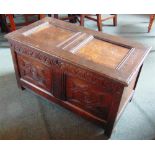 A SMALL OAK COFFER OF PANELLED CONSTRUCTION  with carved decoration, 91cm wide 48cm deep 52cm high