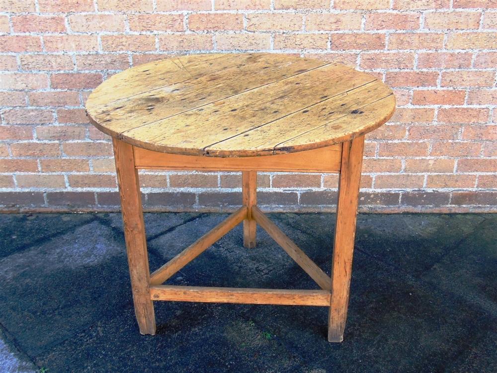 A STRIPPED PINE CRICKET TABLE,  the circular top 87cm diameter 78cm high