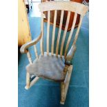 A COMB BACK WINDSOR ROCKING CHAIR,  with deep scroll arms, elm seat and H-shape stretcher (the