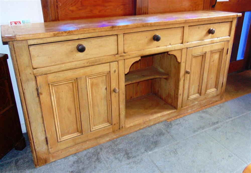 A LARGE STRIPPED PINE DRESSER BASE,  fitted with three drawers over cupboard and pot shelf, 213cm