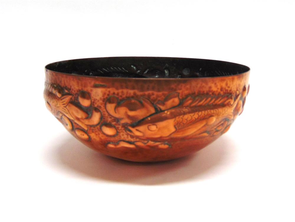 NEWLYN SCHOOL: AN ARTS AND CRAFTS HAMMERED COPPER BOWL decorated with a band of fish swimming