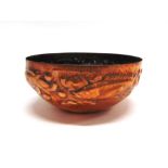NEWLYN SCHOOL: AN ARTS AND CRAFTS HAMMERED COPPER BOWL decorated with a band of fish swimming