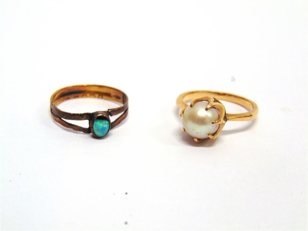 A SINGLE STONE CULTURED PEARL RING unmarked, 3.4g gross; an opal ring, to a 22 carat gold mount, 1.