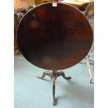 A TILT TOP OCCASIONAL TABLE,  the circular mahogany top 73cm diameter, on tripod base 70cm high