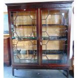 A LARGE MAHOGANY GLAZED BOOKCASE,  the dentil frieze with blind fret decoration above astragal