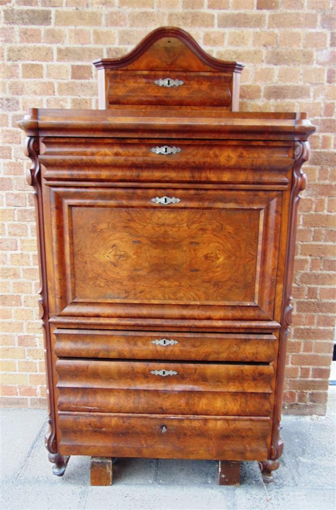 A CONTINENTAL WALNUT SECRETAIRE A ABBATANT fitted with four long moulded drawers and fall front