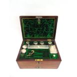 AN EARLY VICTORIAN BRASS MOUNTED ROSEWOOD VANITY BOX,  the fitted interior containing eight glass