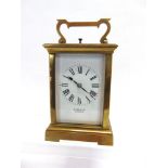 AN 8-DAY BRASS CASED CARRIAGE CLOCK  with repeat mechanism, the enamelled Roman numeral dial