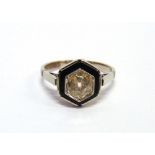 A DIAMOND AND ONYX SINGLE STONE RING the old cut brilliant set to a black onyx border, the diamond