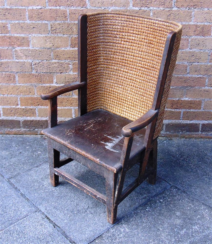 A STAINED PINE AND WOVEN STRAW CHILDS ORKNEY CHAIR,  the wrap-around back to open scroll arms, solid