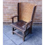 A STAINED PINE AND WOVEN STRAW CHILDS ORKNEY CHAIR,  the wrap-around back to open scroll arms, solid