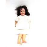 AN ARMAND MARSEILLE BISQUE SOCKET-HEAD DOLL with a replacement black wig, sleeping brown glass eyes,