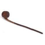 AN UNUSUAL CARVED WOODEN THROWING CLUB  probably Maori, with a whorl shaped head, 43cm long.