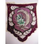 A SUFFRAGETTE BEADED BANNER of shield shape, without wording but finished in the emblematic palate