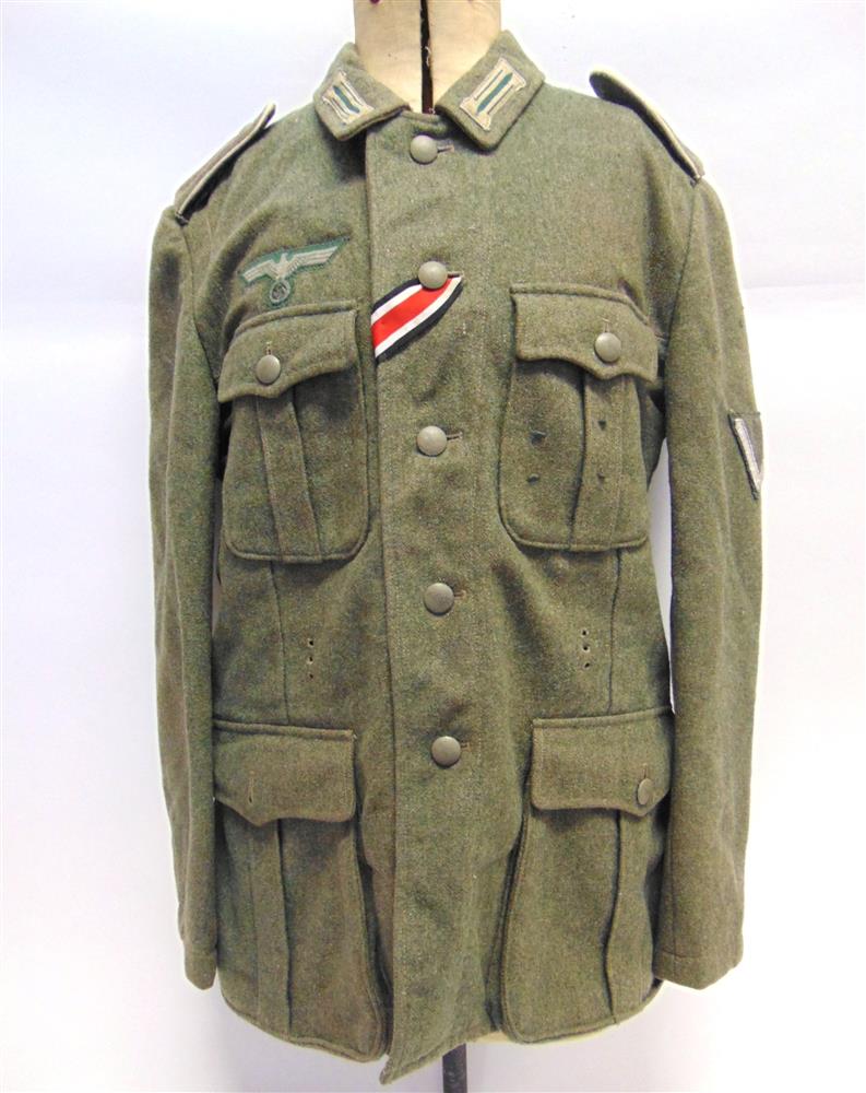 A GERMAN HEER M36 OTHER RANKS FIELD GREY WOOL TUNIC of standard four pocket construction, complete