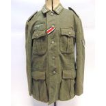 A GERMAN HEER M36 OTHER RANKS FIELD GREY WOOL TUNIC of standard four pocket construction, complete