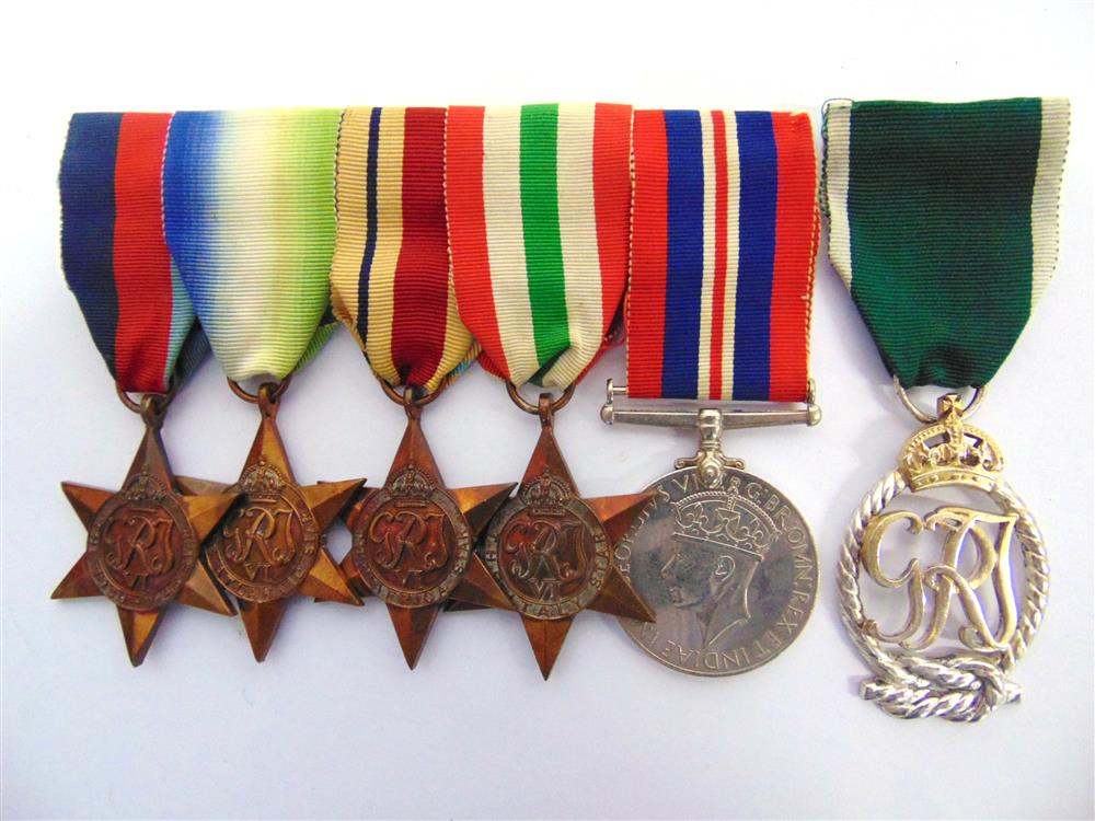 A SECOND WORLD WAR GROUP OF SIX MEDALS ATTRIBUTED TO LIEUTENANT COMMANDER J.D. SAUNDERS, ROYAL NAVAL