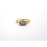 A THREE STONE RING  stamped '18ct' and 'Plat', set with two diamonds and one plate, finger size O,