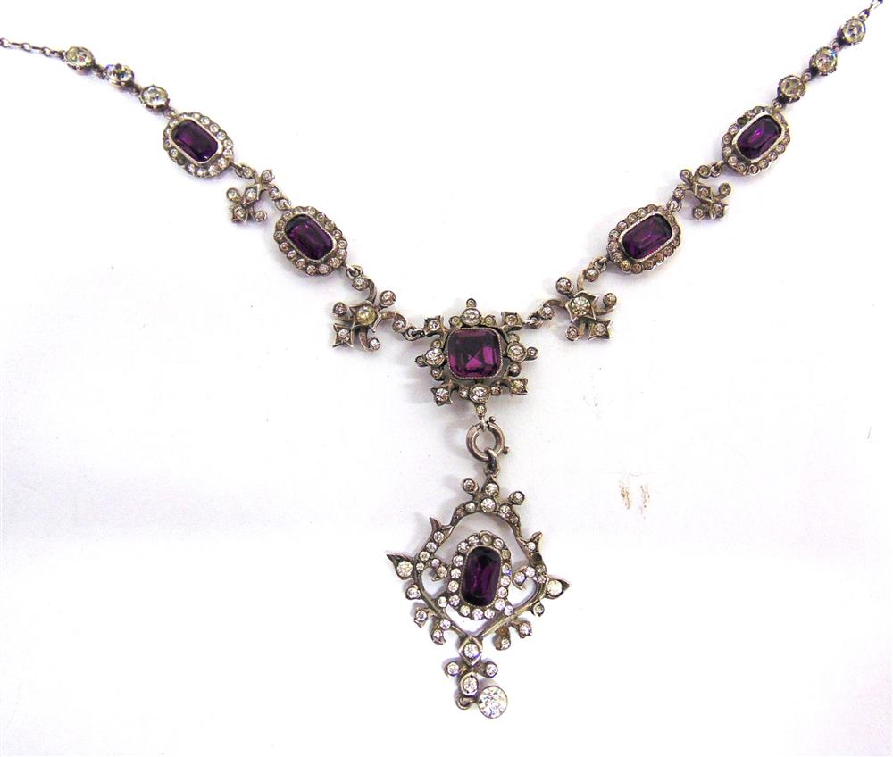 AN EDWARDIAN PASTE NECKLACE the amethyst and colourless pastes arranged as clusters alternating with
