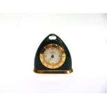 A GUCCI ALARM CLOCK of triangular form, in a simulated malachite and gold coloured case, stamped