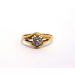 A DIAMOND CLUSTER RING stamped '18ct', set with seven single cut stones, finger size M1/2, 2.3g