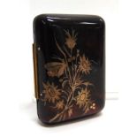 A TORTOISESHELL PIQUEWORK COIN PURSE decorated with a butterfly alighting on flowers, 6.7cm long