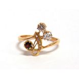 A DIAMOND AND GARNET ART NOUVEAU STYLE RING the two old cut brilliants totalling approximately 0.