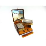 A PAIR OF SILVER GENTLEMANS HAIR BRUSHES with a comb, in a fitted case with mirror to the lid