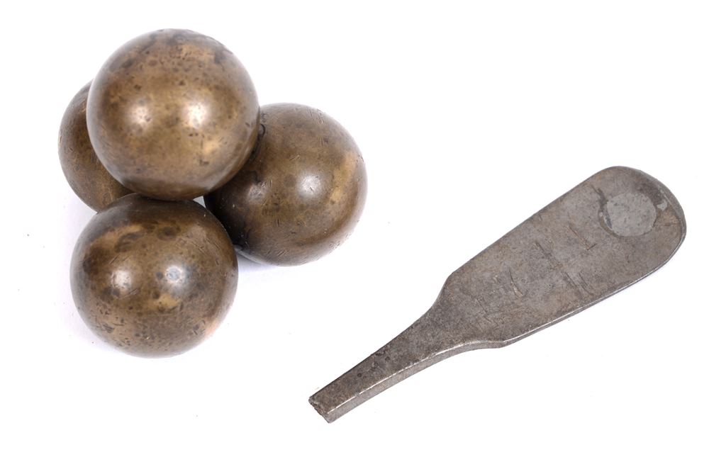 19TH CENTURY - CRIMEA - A STACK OF FOUR BRASS GRAPESHOT  formed as a paperweight; together with a