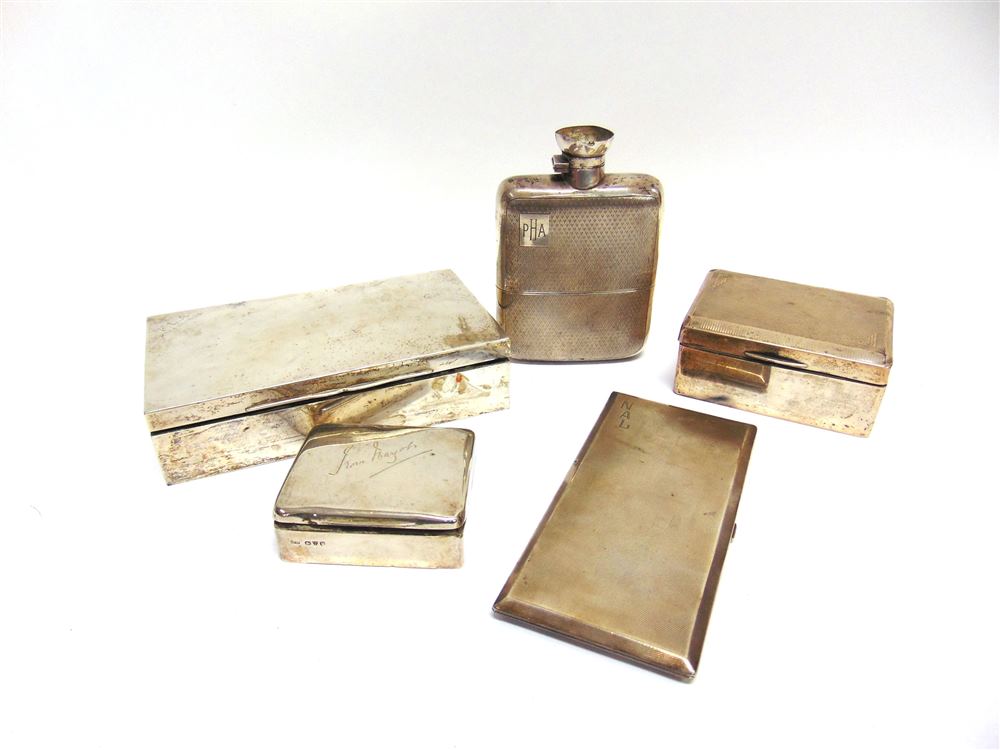 A LARGE SILVER HIP FLASK with a silver cigarette case; and three silver wooden lined cigarette boxes