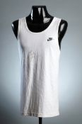 A Michael Johnson signed white Nike running vest, signed across the chest in black marker pen