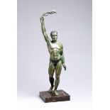 ''Le Vainqueur'', a spelter figure of a classical athlete holding aloft laurel, green patina, set on