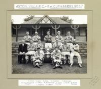 An official b&w photograph of the Aston Villa 1957 F.A. Cup winning team posing with the trophy,
