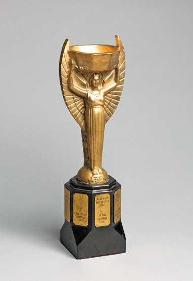 A cast brass replica of the Jules Rimet Trophy circa 1970, a well modelled, heavy replica, the black