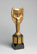 A cast brass replica of the Jules Rimet Trophy circa 1970, a well modelled, heavy replica, the black