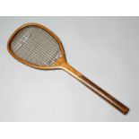 A racquet with slightly tilted head circa mid-1880s, with heavy strings (some breaks), primitive
