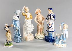 A group of six 19th century ceramic figurines depicting battledore and shuttlecock, including an